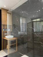 a bathroom with a sink and a glass wall at Belle vue sur mer, très près du port de Sanary in Sanary-sur-Mer