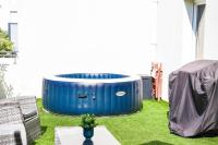 a blue barrel sitting on the grass in a yard at Le Capé-Grand appartement avec terrasse et jacuzzi in Marseille