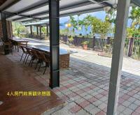 an outdoor patio with a table and chairs at Zhong Ming Ju Taoyi Fang in Fanlu