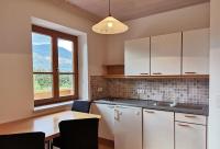 a kitchen with white cabinets and a table and a window at Ferienwohnung Bergblick 