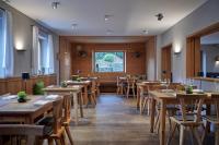 a dining room with wooden tables and chairs at Gasthaus Am Ödenturm in Chammünster