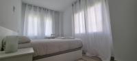 Postel nebo postele na pokoji v ubytování APARTAMENTOS TANEZ SANTURCE a