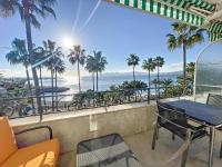 a balcony with a table and chairs and a view of the ocean at Appartement Cannes, 2 pièces, 2 personnes - FR-1-470-27 in Cannes