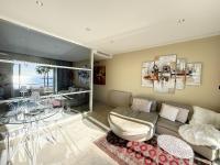 a living room with a couch and a glass table at Appartement Cannes, 2 pièces, 2 personnes - FR-1-470-27 in Cannes