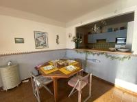 a dining room with a table and chairs and a kitchen at Appartement Casaglione-Tiuccia, 2 pièces, 4 personnes - FR-1-61-477 in Casaglione