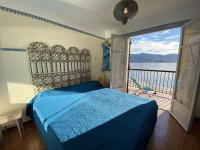 a bedroom with a bed and a view of the water at Appartement Casaglione-Tiuccia, 2 pièces, 4 personnes - FR-1-61-477 in Casaglione