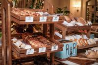 a display of different types of breads and pastries at Four Seasons Hotel Singapore in Singapore