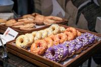 a display of different types of donuts in wooden trays at Four Seasons Hotel Singapore in Singapore