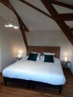 a bedroom with a large white bed with two lamps at Maison piscine Lot in Laburgade