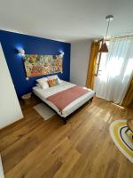 a bedroom with a bed with a blue wall at Maison piscine Lot in Laburgade