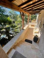 an outdoor patio with stairs and a wooden roof at Maison piscine Lot in Laburgade