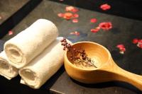 a wooden spoon and towels and a bowl of spices at Yunoyado Onsen Hot Spring Hotel -Xinyi Branch in Jiaoxi