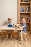 two children sitting at a table with books at Aries Hotel & SPA Wisła in Wisła