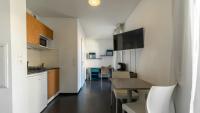 a kitchen and dining room with a table and a counter at Le Stratège in Marseille