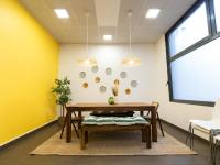 a dining room with yellow walls and a table and bench at Le Stratège in Marseille