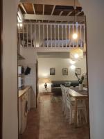 a kitchen and dining room with a table and a loft at Chill Out Cabanon Coeur Calanques in Marseille