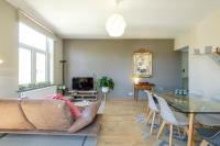 a living room with a couch and a glass table at Charmant Appartement 1 chambre avec balcon proximité Cinquantenaire in Brussels