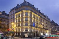 a large white building on a city street at night at Best Western Quartier Latin Pantheon in Paris