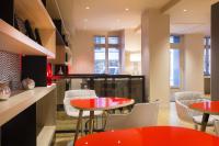 a dining room with red tables and white chairs at Best Western Quartier Latin Pantheon in Paris