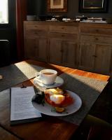 a plate of eggs and a cup of coffee on a table at The Principal Madrid, Small Luxury Hotels in Madrid