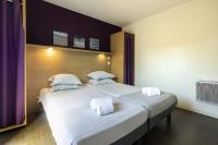 a bedroom with a large bed with two white pillows at Belambra Clubs Capbreton - Les Vignes in Capbreton