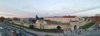 a city with a castle and a street with cars at ApartHotel Sainte-Marthe in Avignon