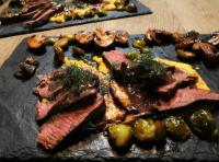 a plate of meat and vegetables on a table at Chez-Judith in Boussenac