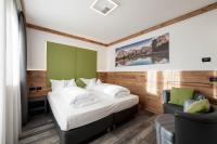 A bed or beds in a room at Hotel Chalet Sas Morin