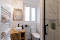 a bathroom with a toilet and a sink and a mirror at DIFY Chalet a la ville - Parilly in Vénissieux