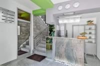 a lobby with a staircase and clocks on the wall at Bed &amp; Breakfast Park Gate in Vranje