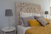 a bedroom with a bed with a wooden headboard at Gite Oliveira&#39;s in Ury