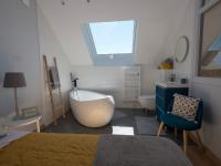 a bedroom with a tub and a bed and a sink at Gite Oliveira&#39;s in Ury