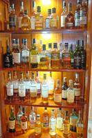 un estante lleno de botellas de alcohol en Knockendarroch Hotel, en Pitlochry