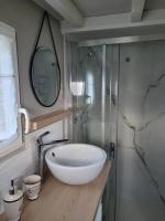 a bathroom with a white bowl sink and a shower at La paillote idyllique in Faverolles-sur-Cher