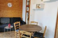 a dining room with a wooden table and chairs at Charmant T2 proche des pistes superbe vue in Chamrousse