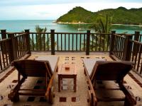 a table and two chairs on a balcony with the ocean at Panviman Resort Koh Phangan - SHA Extra Plus in Thong Nai Pan Noi