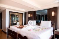 a bedroom with a large white bed with flowers on it at Panviman Resort Koh Phangan - SHA Extra Plus in Thong Nai Pan Noi