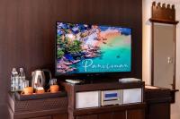 a flat screen tv sitting on top of a entertainment center at Panviman Resort Koh Phangan - SHA Extra Plus in Thong Nai Pan Noi