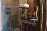 a bathroom with a sink and a shower with a roll of toilet paper at Panviman Resort Koh Phangan - SHA Extra Plus in Thong Nai Pan Noi