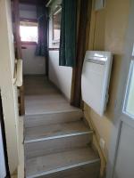 a hallway with stairs in a tiny house at La paillote idyllique in Faverolles-sur-Cher