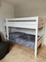 a white bunk bed in a room with a couch at Gite Himaya - Vaison la Romaine in Vaison-la-Romaine