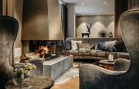 a living room with a couch and a fireplace at Grand Tirolia Kitzbühel - Member of Hommage Luxury Hotels Collection in Kitzbühel