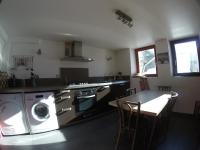 a kitchen with a washing machine and a table at Villa Jules in Chamonix