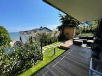 a backyard with a wooden deck and a view of the ocean at Grafit in Mechelinki