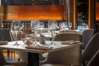 a table in a restaurant with wine glasses on it at Velvet Hotel Manchester, WorldHotels Crafted in Manchester
