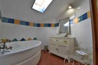 a bathroom with a tub and a sink and a mirror at Gite de groupe &quot;L&#39;Unisson&quot; Domaine La Rose des Vents in Castelnau-sur-lʼAuvignon