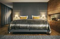 a bedroom with a large bed with a large headboard at Grand Tirolia Kitzbühel - Member of Hommage Luxury Hotels Collection in Kitzbühel