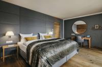 a bedroom with a large bed and a mirror at Grand Tirolia Kitzbühel - Member of Hommage Luxury Hotels Collection in Kitzbühel