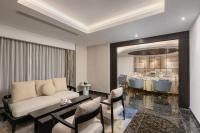 a living room with a couch and a dining room at Yangon Thanlwin Hotel in Yangon