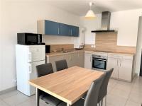 a kitchen with a wooden table and chairs in it at Appartement Quiberon, 2 pièces, 2 personnes - FR-1-478-162 in Quiberon